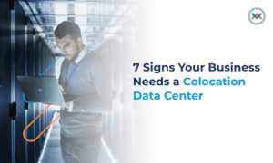 Person holding a laptop inside a colocation data center facility